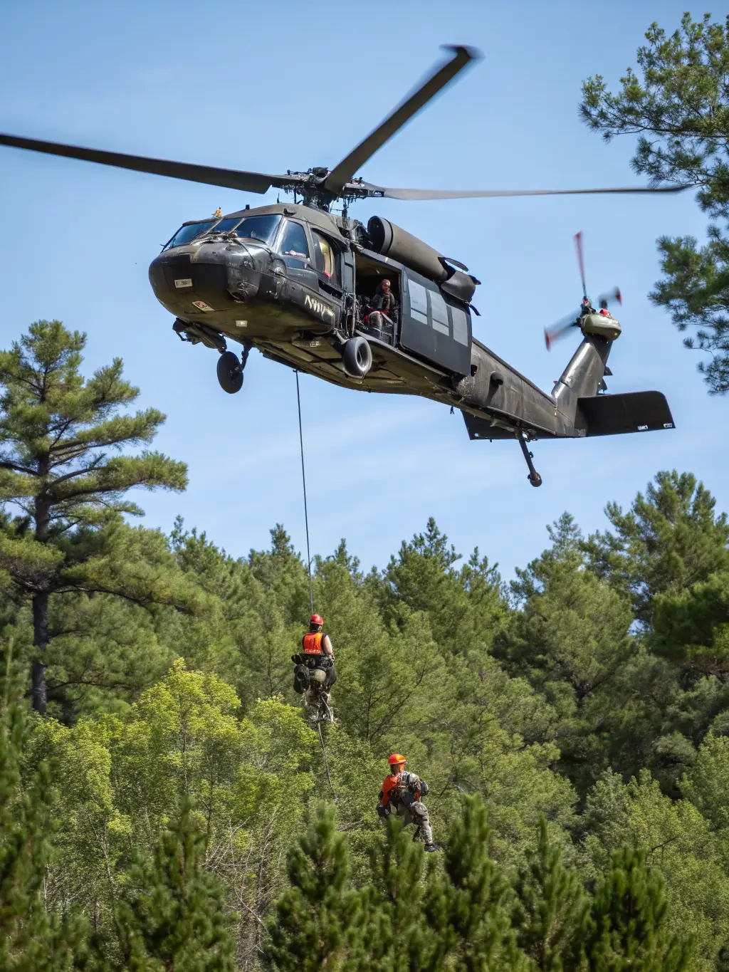 A wide shot of an Army aviation officer piloting a helicopter during a search and rescue mission, with a mountainous landscape in the background. The officer is focused and determined, demonstrating their expertise in aviation and emergency response.